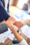 team members gripping wrists in unity gesture