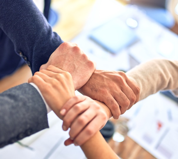 person in black long sleeve shirt holding persons hand