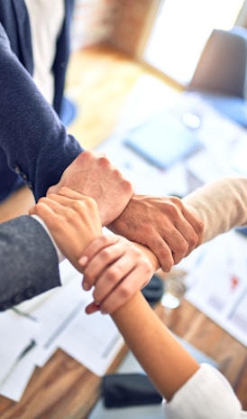 person in black long sleeve shirt holding persons hand