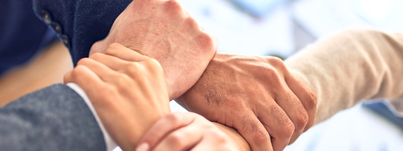 person in black long sleeve shirt holding persons hand