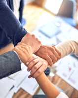 person in black long sleeve shirt holding persons hand