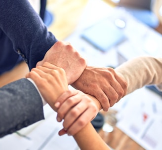 person in black long sleeve shirt holding persons hand