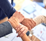 person in black long sleeve shirt holding persons hand