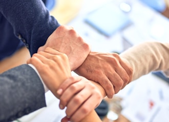 person in black long sleeve shirt holding persons hand