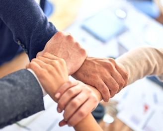 person in black long sleeve shirt holding persons hand