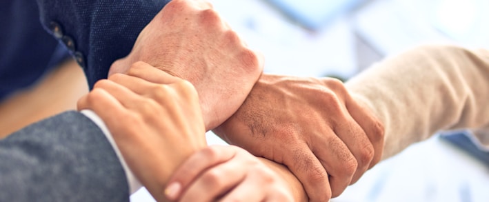 person in black long sleeve shirt holding persons hand