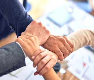 person in black long sleeve shirt holding persons hand