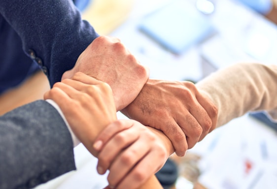 person in black long sleeve shirt holding persons hand