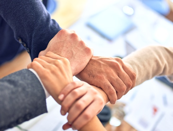 person in black long sleeve shirt holding persons hand