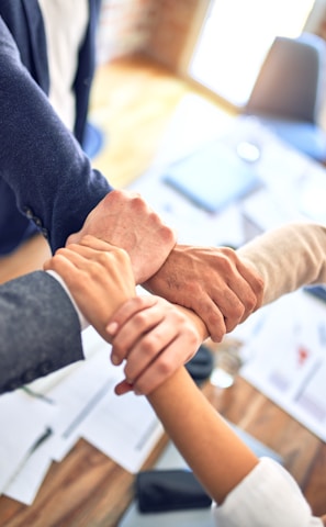 person in black long sleeve shirt holding persons hand