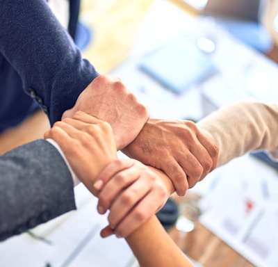 person in black long sleeve shirt holding persons hand