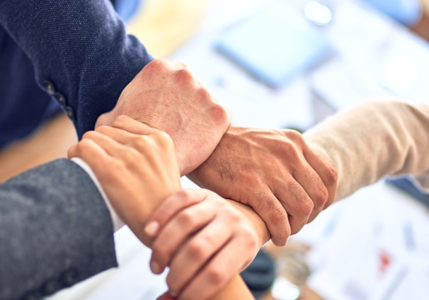 person in black long sleeve shirt holding persons hand