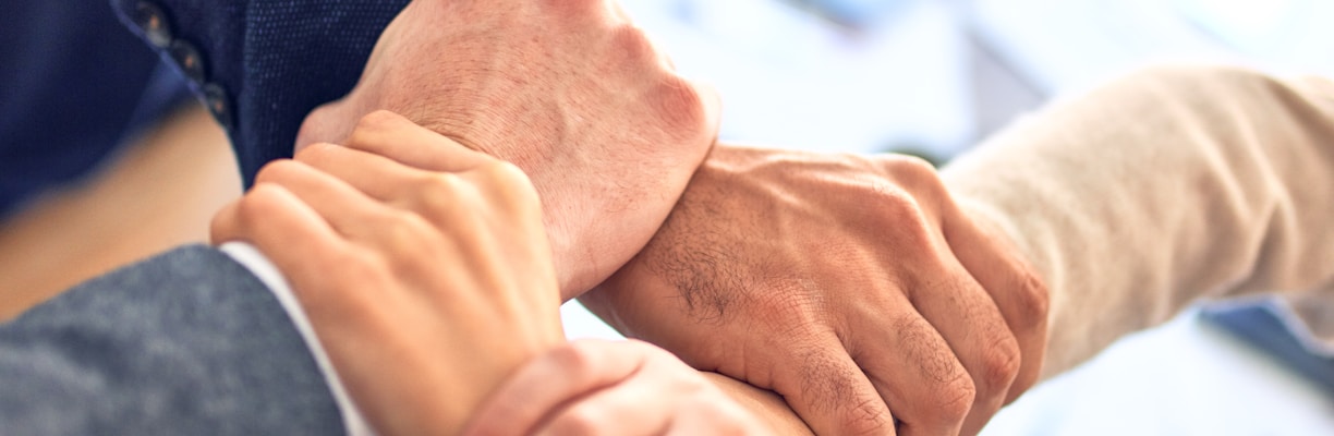 person in black long sleeve shirt holding persons hand