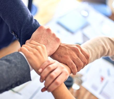 person in black long sleeve shirt holding persons hand