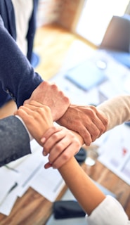 person in black long sleeve shirt holding persons hand