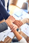 person in black long sleeve shirt holding persons hand