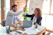 man in white dress shirt sitting beside woman in black long sleeve shirt