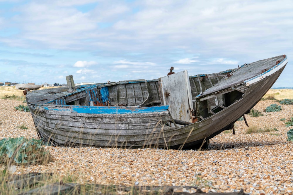 brown and white boat on brown sand during daytime