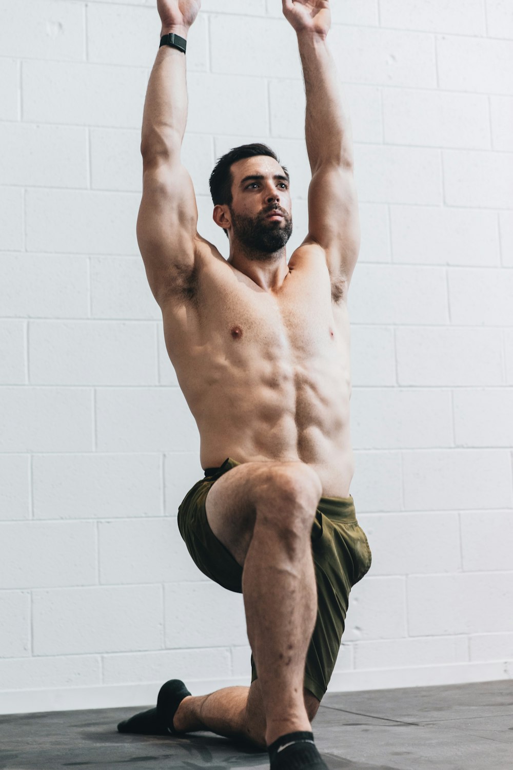 man in green shorts raising his both hands