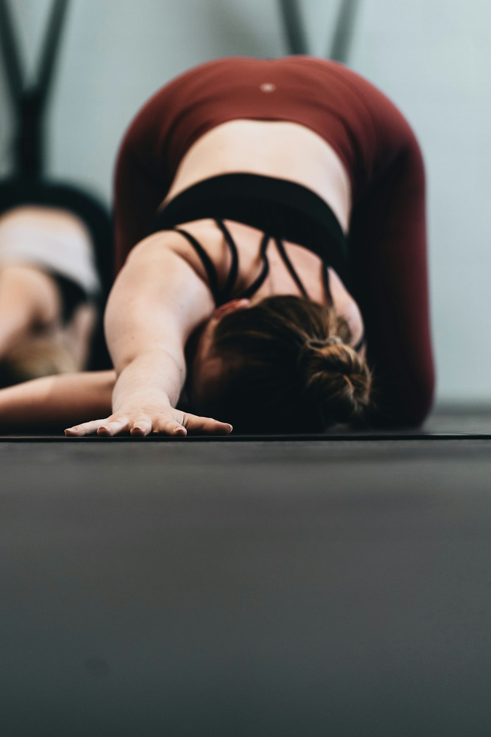 woman in red tank top lying on floor