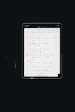 Open digital tablet displaying a beautifully designed self-care checklist with gold and cream accents