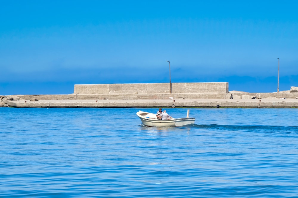 white and blue boat on sea during daytime