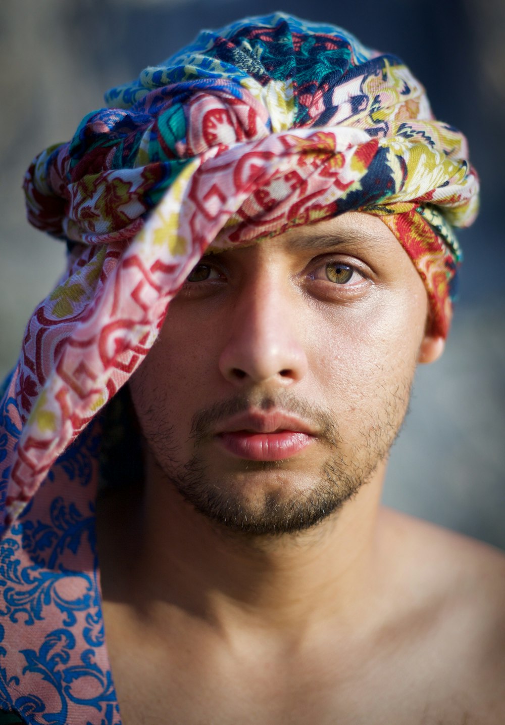 man with multi colored floral scarf