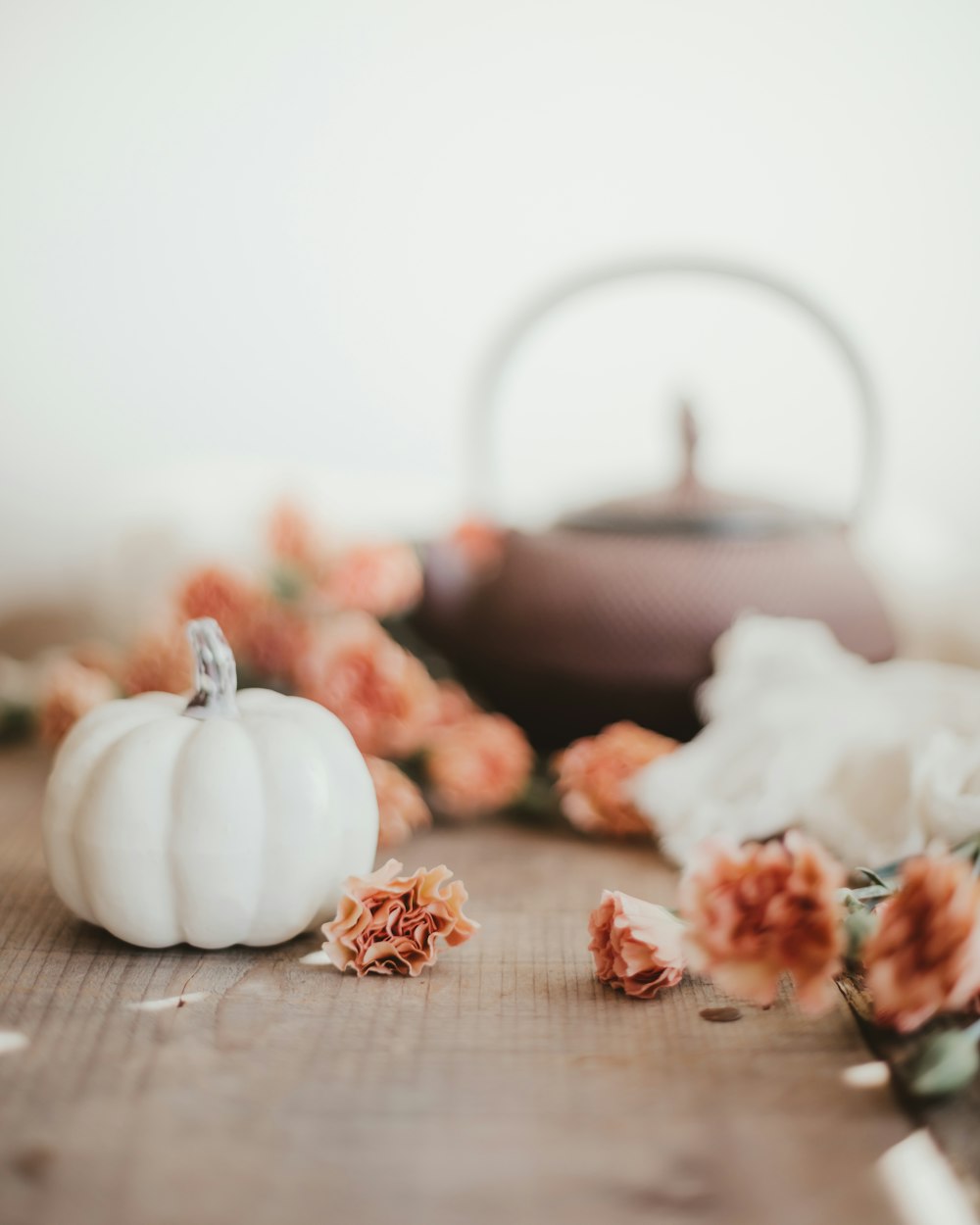 white and orange pumpkin on brown wooden table