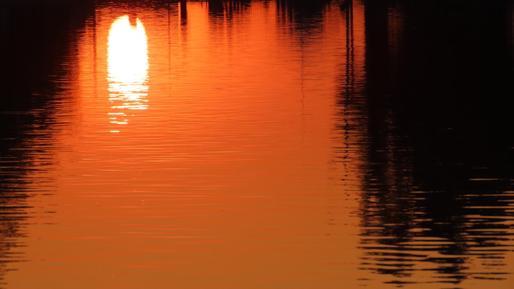 body of water during sunset