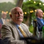 man in gray suit jacket sitting on chair