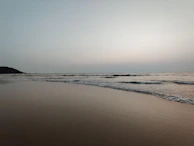 A serene nature scene with gentle waves lapping a quiet shore, evoking tranquility.