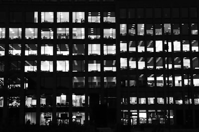 black and white glass building with lights on