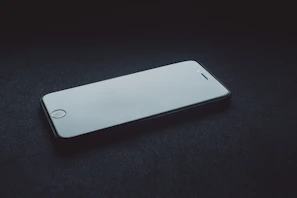 A sleek smartphone displayed on a clean white surface with a subtle shadow