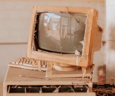 brown crt tv on white wooden table