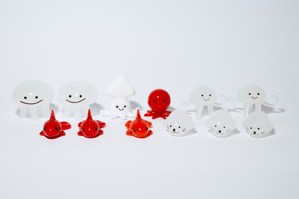 white and red plastic duck toys