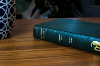 green book on brown wooden table