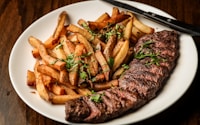 Some beautiful bastard cut up this delightful steak for me to photograph with truffle oil fries on the side. Part of the C9 Work WordPress Theme sample content imagery.