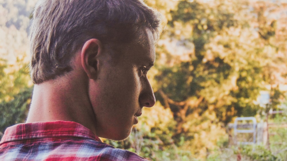 man in red blue and white plaid shirt