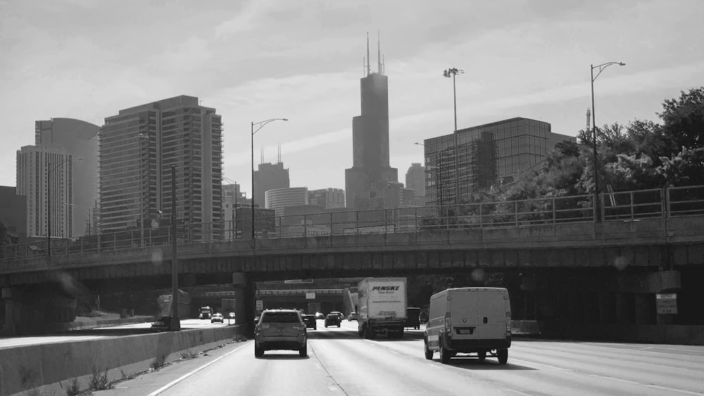 cars on road near high rise buildings during daytime