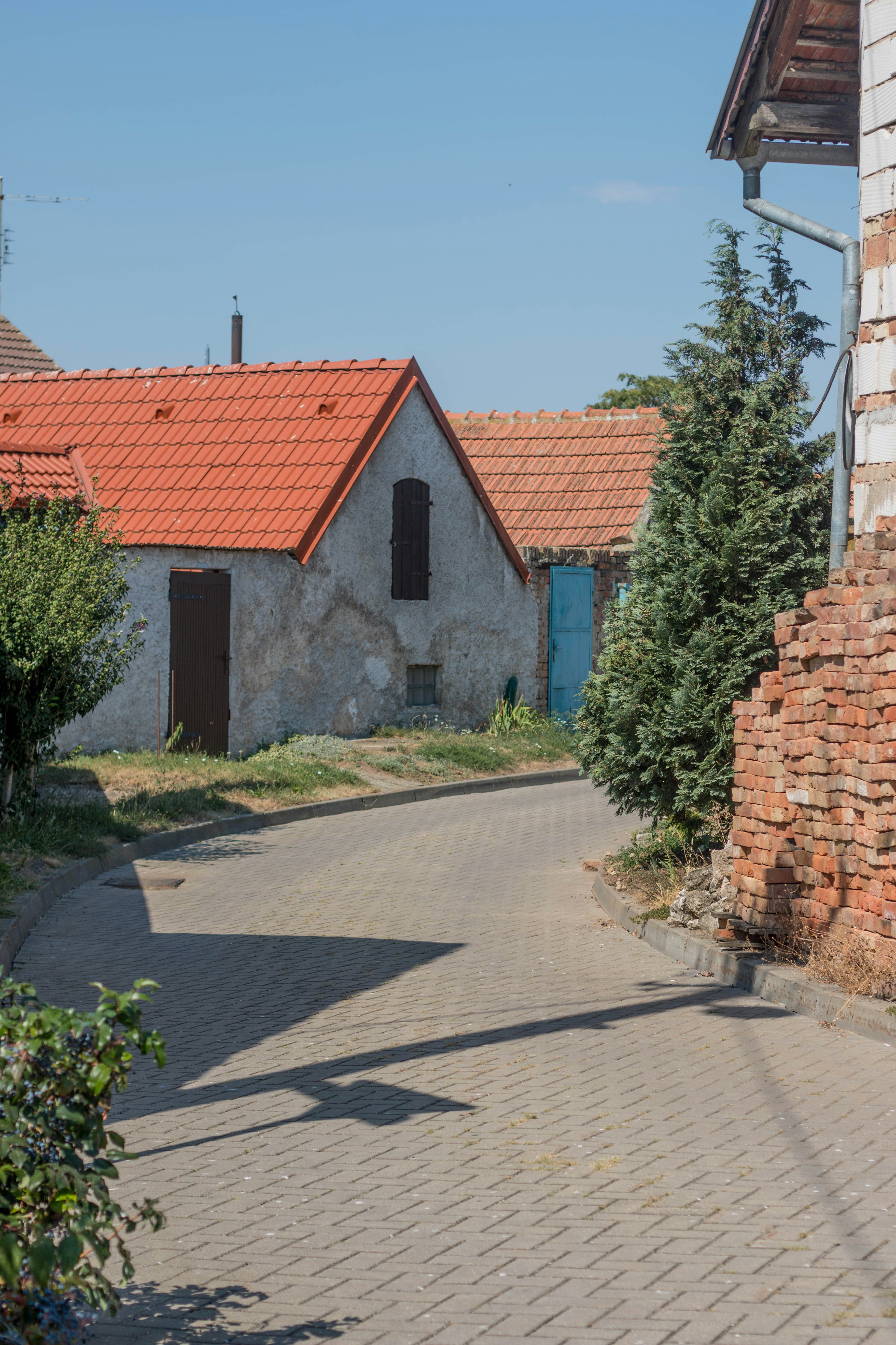 gray and brown concrete house near green trees during daytime