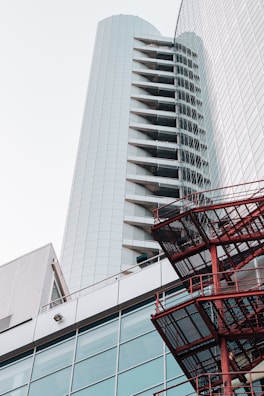 red shopping cart near gray concrete building during daytime