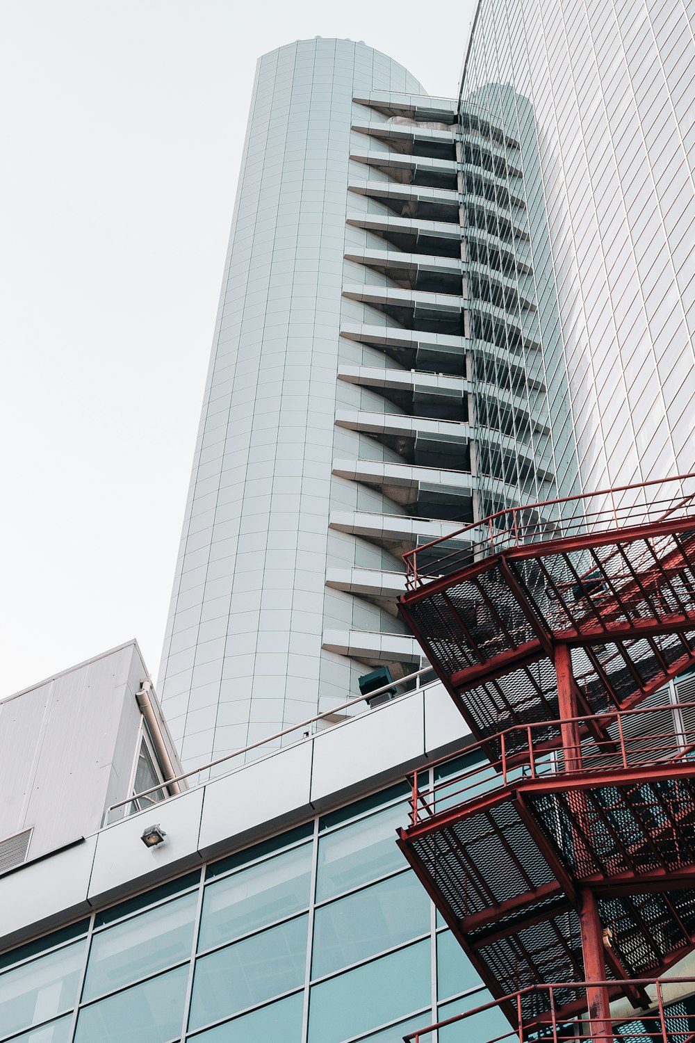 red shopping cart near gray concrete building during daytime