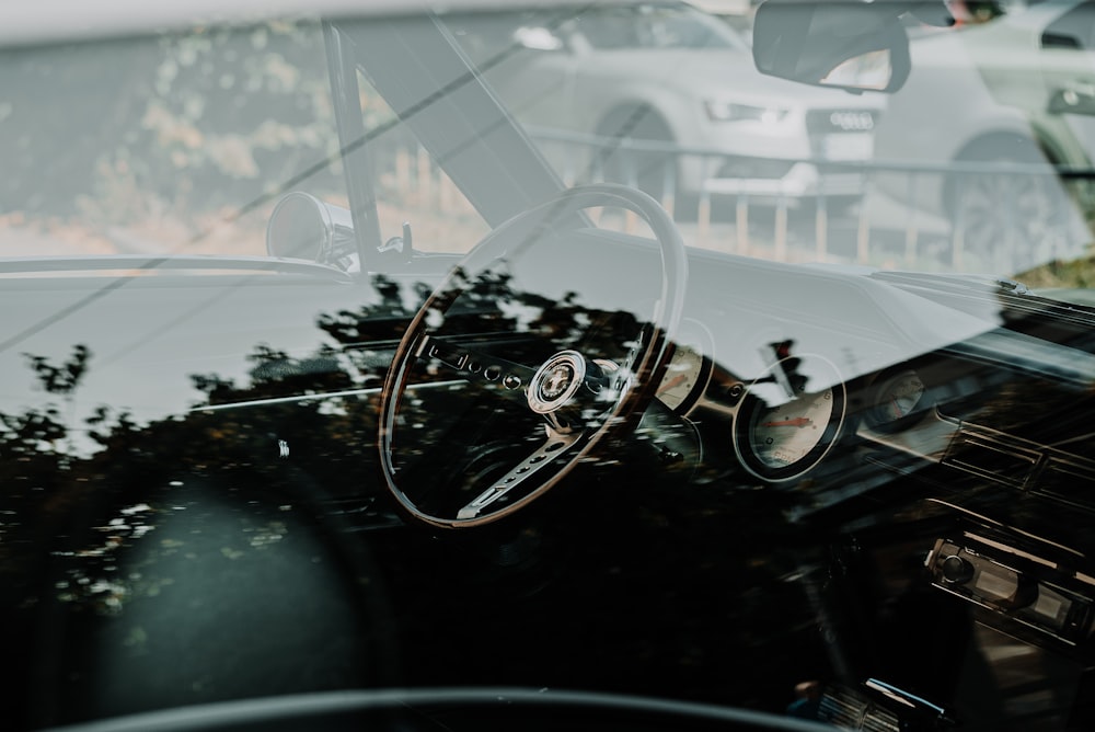 black and silver motorcycle in front of white car