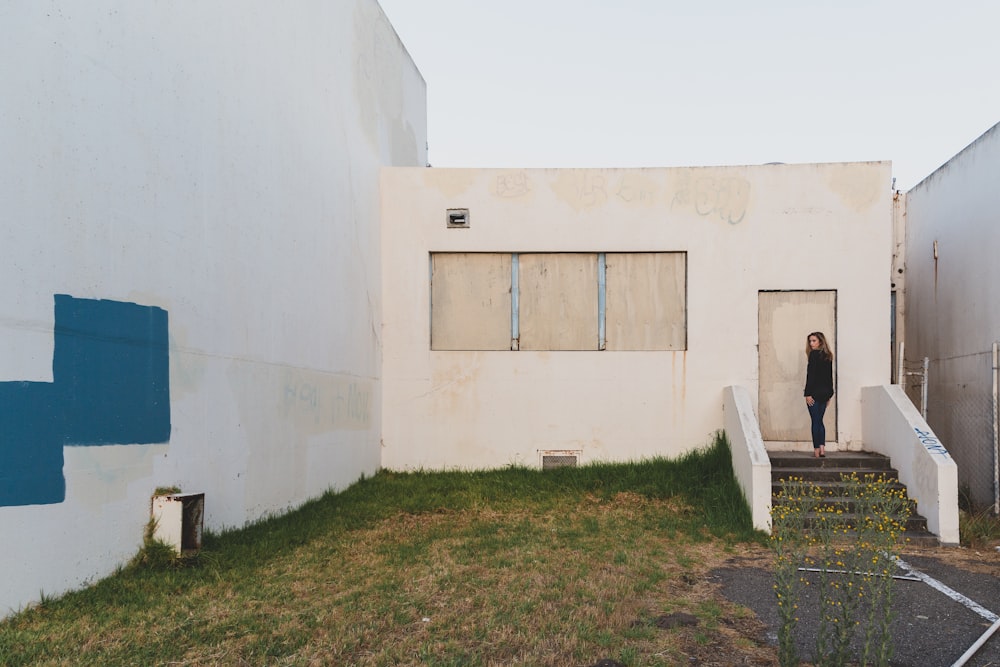 white concrete building with brown wooden door