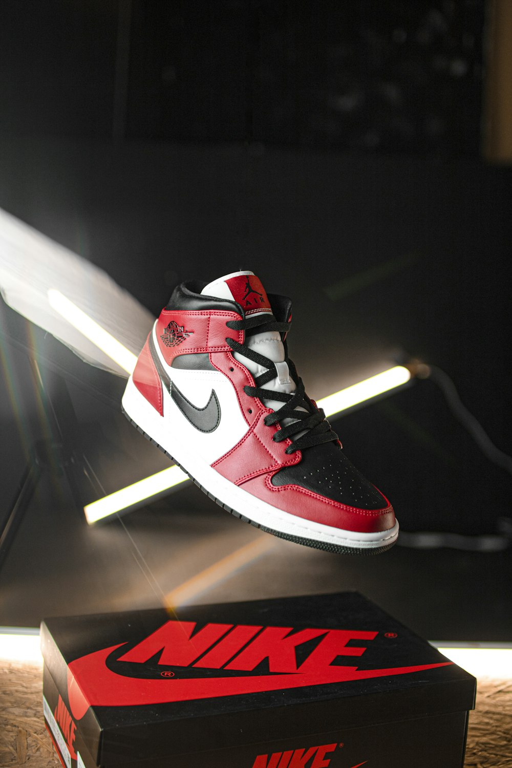 black white and red nike high top sneakers