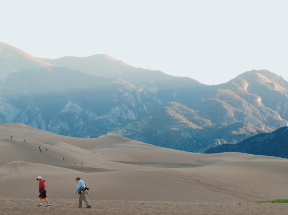 people walking on desert during daytime