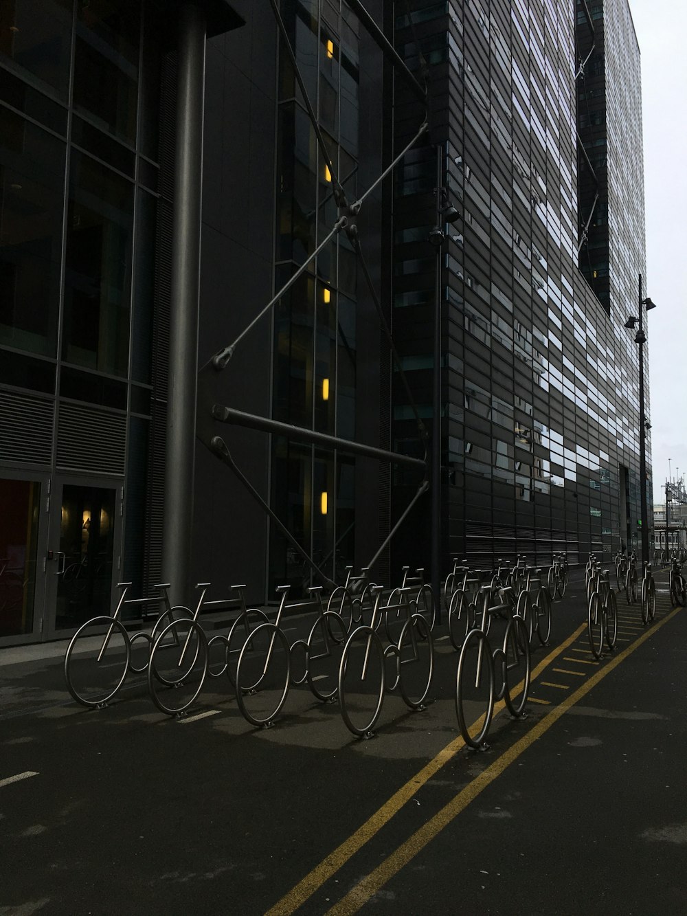 gray metal fence near gray concrete building during daytime