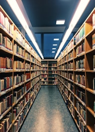 brown wooden book shelves in library