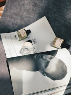 Flat lay of a luxury editorial magazine spread with italic serif accents and subtle shadows