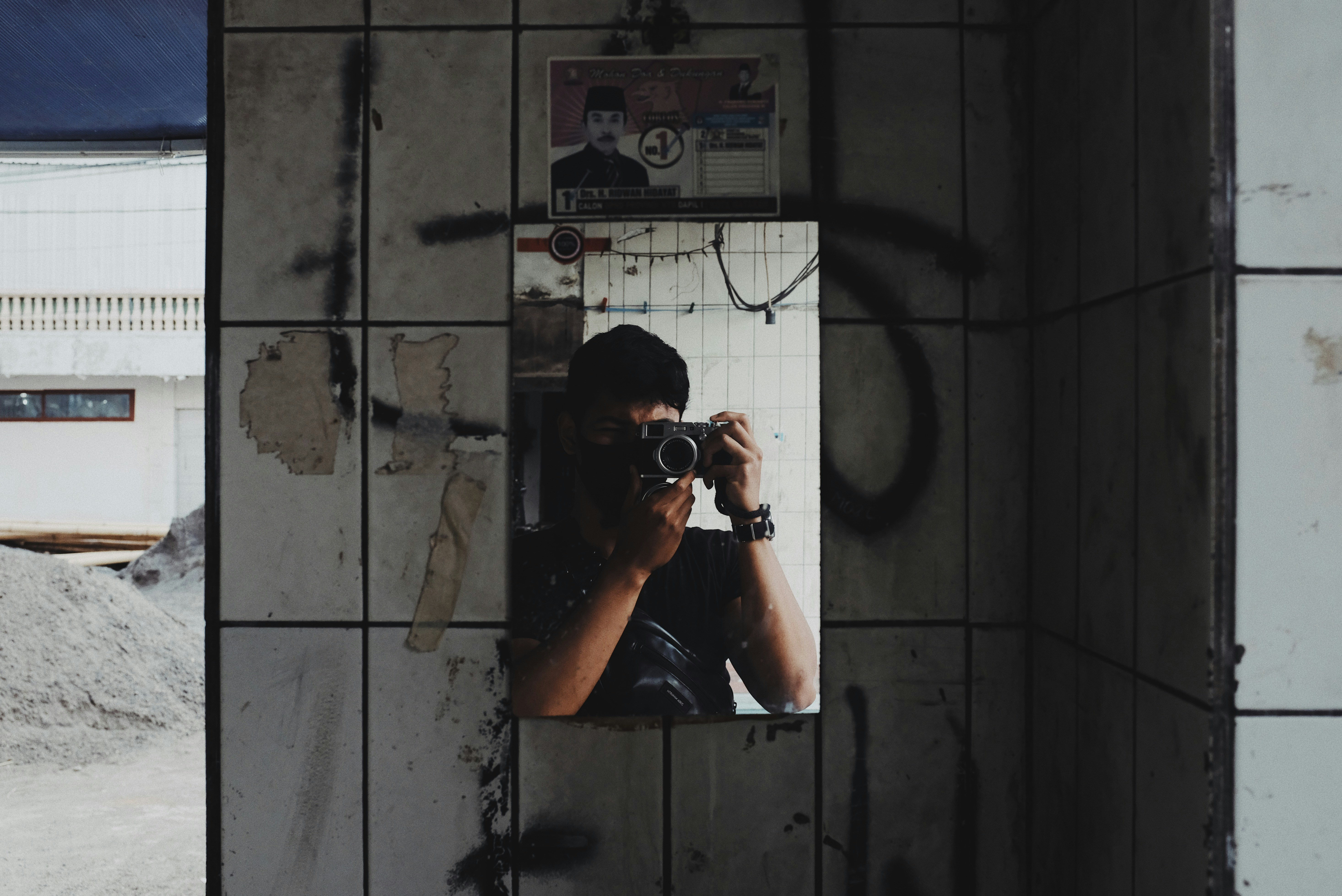 man taking photo of mirror